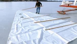 A big main needs big battens! Peter Fauerbach takes advantage of the perfect workspace on a perfect day to install our new battens on the B's recently-cleaned sails