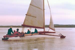 Jim Payton on the tiller, Tony Perme in the bucket and a few passengers. Lake Mendota, February 1980